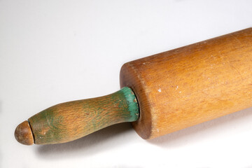 Close up of a vintage wooden rolling pin isolated on a white background