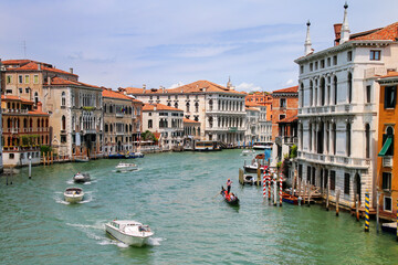 View of Grand Canal with houses and motorboats in Venice, Italy