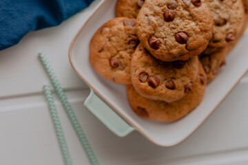 Chocolate chip cookies and white wooden background