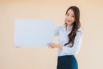 Portrait beautiful young asian business woman show white empty billboard banner