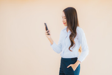 Fototapeta premium Portrait beautiful young business asian woman with smart mobile phone and coffee