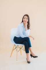 Portrait beautiful young business asian woman sit on chair with laptop or smart phone