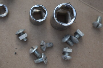 Nuts, Bolts, and Sockets on Cardboard