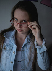 Pretty and young model with blue eyes using glasses