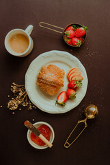 coffee and croissant with strawberry jam