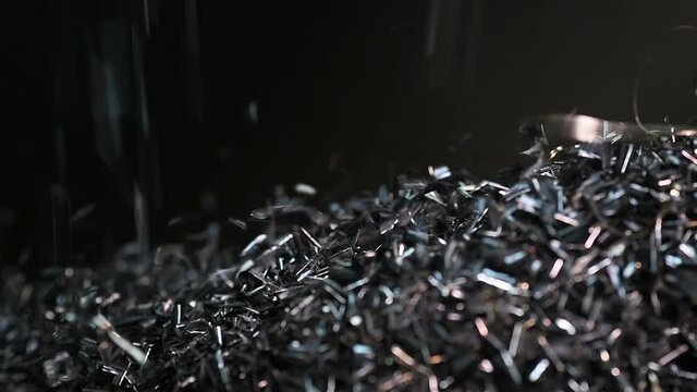 Metal part is manufactured with drill steel metal lathe machine engine, technology in operation process industry manufacturing plant factory. Raw product equipment in warehouse. Shavings fall
