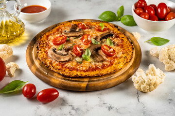 Close up of delicious and cheesy vegetarian cauliflower pizza on white background