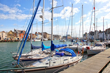 Sailing boats in the old town of Weymouth Harbour in Dorset, England, UK.