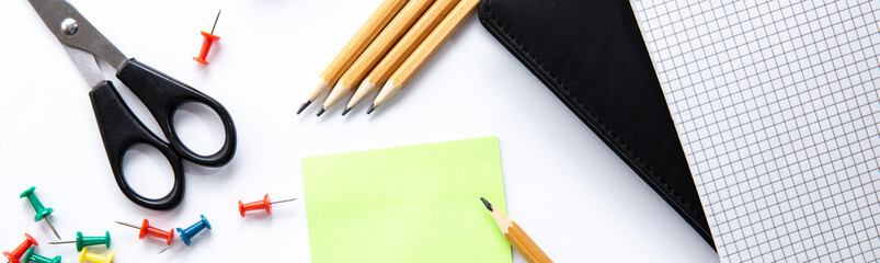 Banner with stationery. Background of school or office accessories. Note, pencil, scissors, push pins, sticker for notes on white desk. Success and creative concept. Idea of a diligent study or work