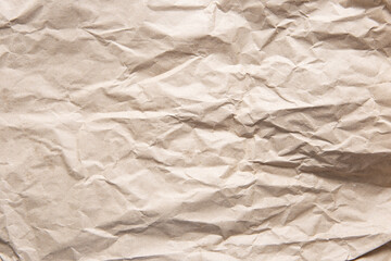Obraz premium Crumpled old brown yellow paper. Rough old texture. Abstract background with space for text. Aging concept