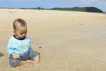 A beautiful cute indonesian baby on the beach