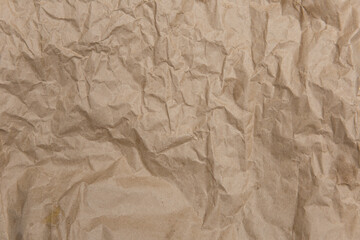 Crumpled old brown yellow paper. Rough old texture. Abstract background with space for text. Aging concept