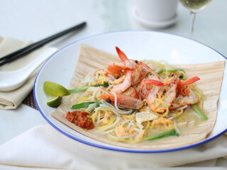 Singapore Hokkien Mee on White Table. Prawn Noodles Closeup.