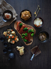 Glazed Pork Ribs Flatlay on Wooden Table with Copy Space. Caramelized Pork Belly with Chinese Tea. Barbecued Pork with Broccoli.