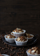 Mocha Almond Muffins Still Life. Coffee Muffins on Dark Background with Copy Space. Rustic Food Photography of Freshly Baked Mocha Muffins.