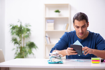 Young man in budget planning concept