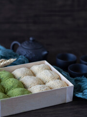 Matcha Daifuku Mochi (Green Tea Mochi With Red Bean Fillings). Green Tea Daifuku on Dark Background with Copy Space. Still life, dark food photography of Warabi Mochi.