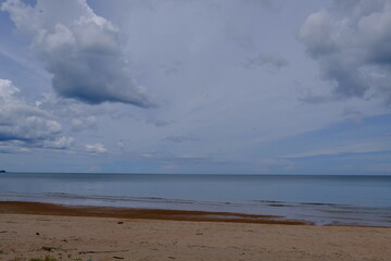 Bright beautiful seascape, sandy beach, clouds reflected in the water, natural minimalistic background and texture