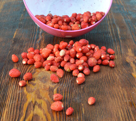 
sweet strawberry lies on a brown wooden background