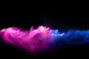 Gordijnen Pink blue dust particles splash on black background.Pink blue powder splash. © Pattadis
