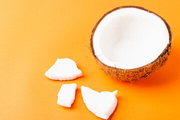 Happy coconuts day concept, fresh coconut group set different half and slices, studio shot isolated on orange background