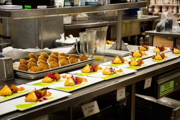 Brazilian appetizer, esfiha and coxinha plated up at restaurant's kitchen
