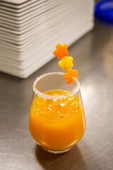Passion fruit mocktail, with orange and lemon peels garnish in a shape of flowers