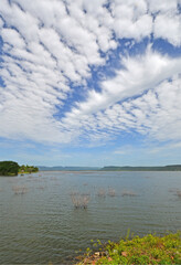 Beautiful cloudy sky over the lake and the mountains