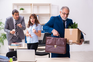 Two male and one female employees working in the office