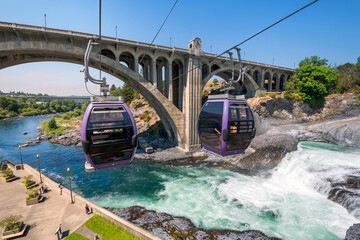 Two gondolas fly over the Spokane River and falls near Riverfront Park on a summer day in Spokane, Washington, USA © Kirk Fisher