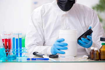 Young male chemist working in medicine lab