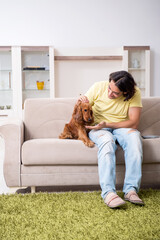 Young man with cocker spaniel dog