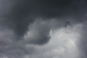 Natural toned emotional day sky background. Heavy cloud formation in stormy dark sky, strong wind and hard rain. Rainy season day atmosphere.