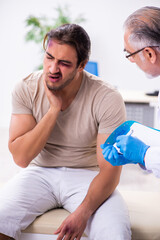 Young face injured man visiting experienced male doctor traumato