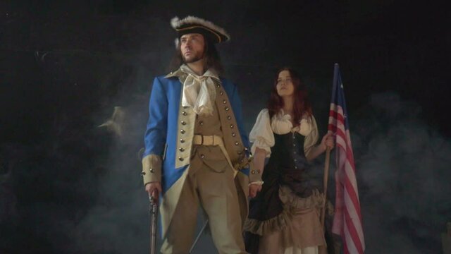 Young patriot girl in historical dress and officer in form of rebels. Historical concept from American Revolutionary War