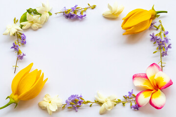 Naklejka na ściany i meble yellow flowers ylang ylang, frangipani ,jasmine and purple flowers local flora of asia in spring season arrangement flat lay postcard style on background white