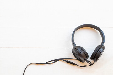 black headphone of listening of lifestyle on background white wooden