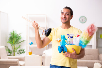 Young male contractor doing housework at home