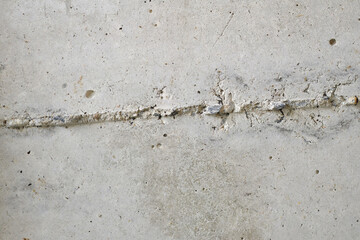 concrete wall surface has gray cracks as the background.
