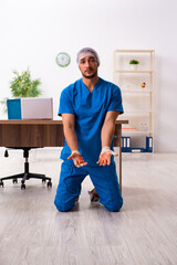 Young male doctor surgeon in fatal negligence concept