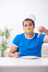 Young hungry man in dieting concept