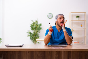 Young male doctor surgeon in fatal negligence concept