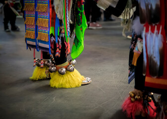 American Indian dancers in handmade beaded leather moccasins decorated with jingle bells at a...