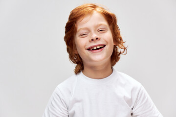 Cheerful boy red hair freckles on his face after outline of demon joy 