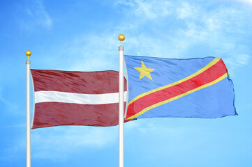 Latvia and Congo Democratic Republic two flags on flagpoles and blue sky
