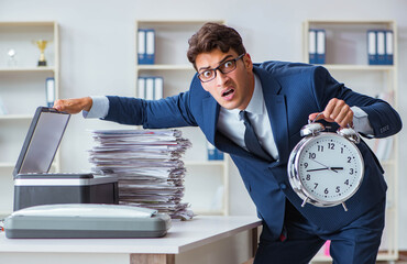 Businessman making copies in copying machine