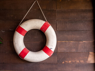 Sea lifebuoy on wooden background . Copy space for individual text.