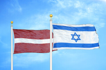 Latvia and Israel two flags on flagpoles and blue sky