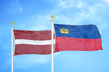 Latvia and Liechtenstein two flags on flagpoles and blue sky