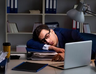 Businessman tired and sleeping in the office after overtime hour